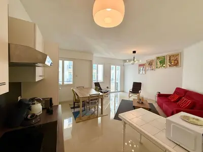 a white bedroom with a bed and a window at C083 Croisette - 1 chambre - Vue Epoustouflante in Cannes