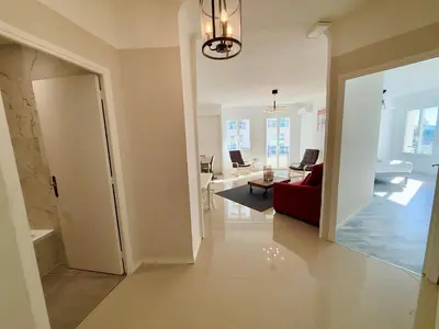 a room with a red couch and a living room at C083 Croisette - 1 chambre - Vue Epoustouflante in Cannes