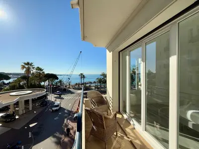 a balcony with chairs and a view of a city at C083 Croisette - 1 chambre - Vue Epoustouflante in Cannes