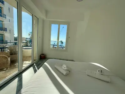 a table on a balcony with a view of a street at C083 Croisette - 1 chambre - Vue Epoustouflante in Cannes