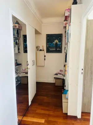a room with white walls and a wooden floor at Appartement face mer LES PRINCES in Cannes