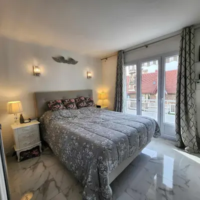 a bedroom with a bed and a large window at Victoria - Dr Picaud - 3 Pieces avec climatisation - 5 min des Plages in Cannes
