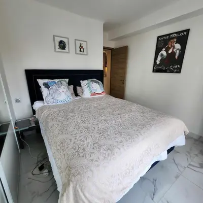 a bedroom with a large bed with a white comforter at Victoria - Dr Picaud - 3 Pieces avec climatisation - 5 min des Plages in Cannes