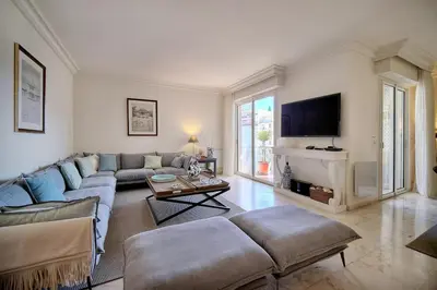 a living room with a couch and a tv at REF 1482 - Cannes Back Croisette - Apartment for rent in Cannes