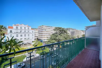 a balcony with a view of a city at REF 1482 - Cannes Back Croisette - Apartment for rent in Cannes