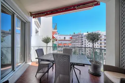 a balcony with a table and chairs on a balcony at REF 1482 - Cannes Back Croisette - Apartment for rent in Cannes