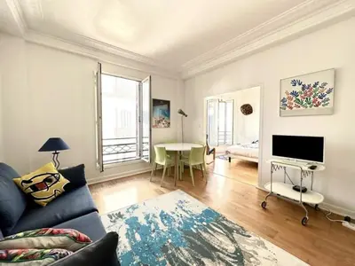 a living room with a couch and a table at Charming apartment steps away from La Croisette and Palais de Festival in Cannes