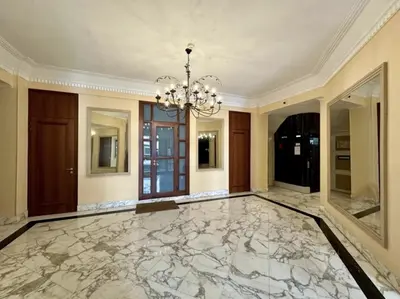 a large room with a marble floor and a chandelier at Charming apartment steps away from La Croisette and Palais de Festival in Cannes