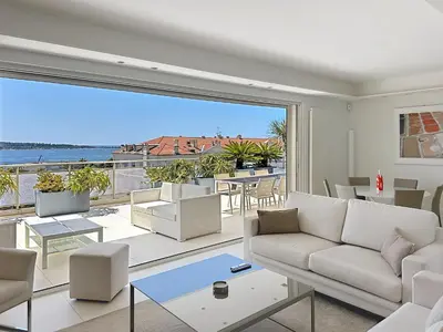 a living room with a couch and a large window at Penthouse 2-Bedroom apartment with 360º views and parking in Cannes