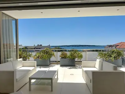 a kitchen with a counter and a table and chairs at Penthouse 2-Bedroom apartment with 360º views and parking in Cannes