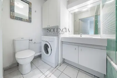 a white bathroom with a toilet sink and a washing machine at 2 pièces - Très proche Croisette et Palais des Festivals in Cannes