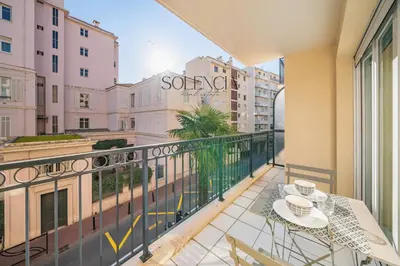 a balcony with a table and a view of a city at 2 pièces - Très proche Croisette et Palais des Festivals in Cannes