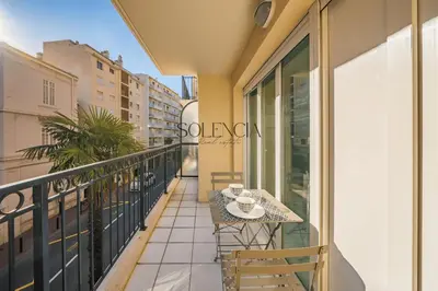 a balcony with a table and chairs on it at 2 pièces - Très proche Croisette et Palais des Festivals in Cannes