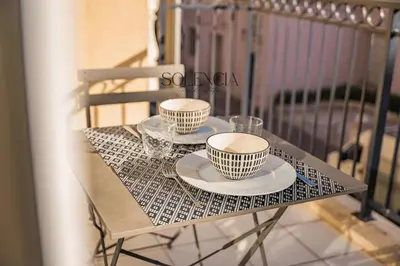 a table with two tea cups and glasses on it at 2 pièces - Très proche Croisette et Palais des Festivals in Cannes