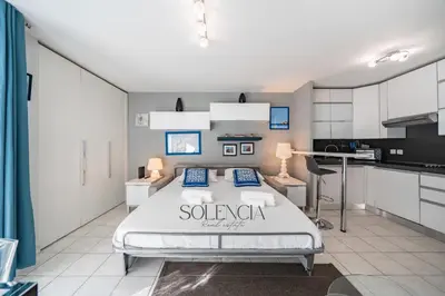 a bedroom with a large bed in a kitchen at 2 pièces - Très proche Croisette et Palais des Festivals in Cannes