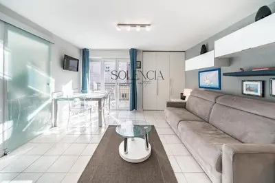 a living room with a couch and a table at 2 pièces - Très proche Croisette et Palais des Festivals in Cannes