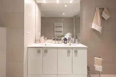 a bathroom with a white sink and a mirror at Luxueux appartement proche de la Croisette avec grande terrasse aménagée in Cannes