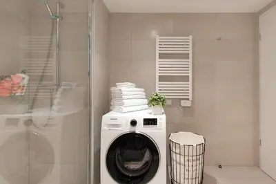 a washing machine in a bathroom with a shower at Luxueux appartement proche de la Croisette avec grande terrasse aménagée in Cannes
