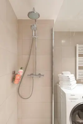 a shower in a bathroom with a washing machine at Luxueux appartement proche de la Croisette avec grande terrasse aménagée in Cannes