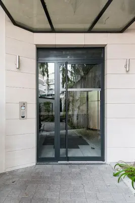 an entrance to a building with glass doors at Luxueux appartement proche de la Croisette avec grande terrasse aménagée in Cannes