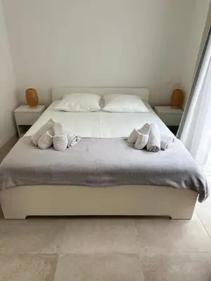 a bedroom with a white bed with towels on it at Maison 4pièces -Haut Standing CANNES in Cannes