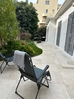 a towel is sitting on a chair on a patio at Maison 4pièces -Haut Standing CANNES in Cannes