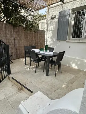 a table and chairs sitting on a patio at Maison 4pièces -Haut Standing CANNES in Cannes