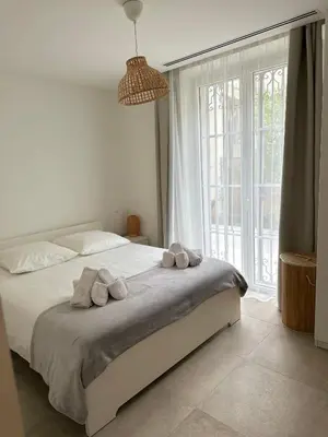 a bedroom with a large bed with towels on it at Maison 4pièces -Haut Standing CANNES in Cannes