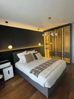 a bedroom with a large bed with a black wall at Appartement Moderne à Cannes in Cannes