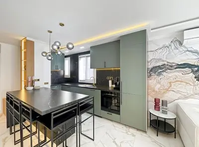 a kitchen with a large painting on the wall at Appartement Moderne à Cannes in Cannes