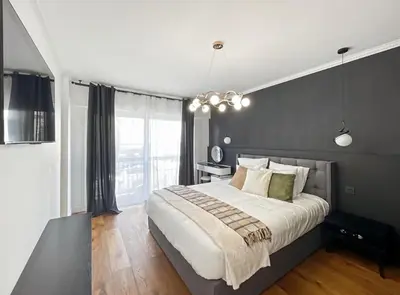 a bedroom with a large bed and a large window at Appartement Moderne à Cannes in Cannes
