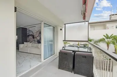 a balcony with a view of a living room with a couch at Appartement Moderne à Cannes in Cannes