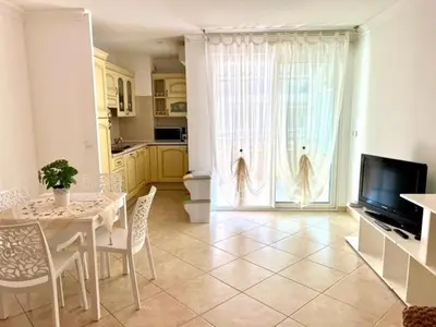 a kitchen with a table and chairs and a television at Very bright T2 near beach in Cannes