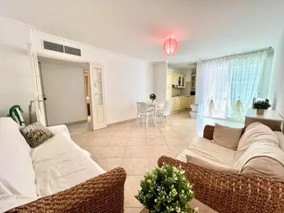 a living room with a couch and a table at Very bright T2 near beach in Cannes