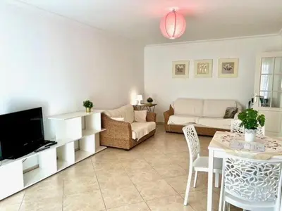 a living room with a couch and a table at Very bright T2 near beach in Cannes