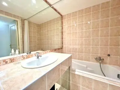 a bathroom with a sink and a bath tub at Very bright T2 near beach in Cannes