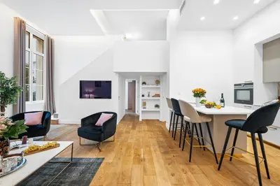 a living room with a table and chairs at Jessicannes Hoche 4 min Palais Festival & Beaches in Cannes