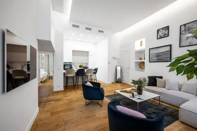 a living room with a couch and chairs and a table at Jessicannes Hoche 4 min Palais Festival & Beaches in Cannes