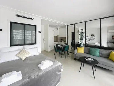a living room with a large bed and a couch at Studio apartment on La Croisette with terrace in Cannes