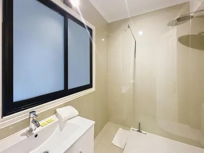 a bathroom with a sink and a large window at Studio apartment on La Croisette with terrace in Cannes