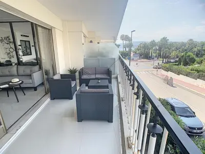 a balcony with furniture and a view of a street at Studio apartment on La Croisette with terrace in Cannes