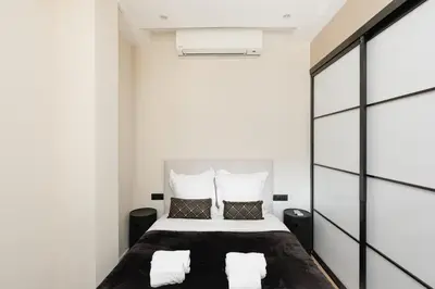 a bedroom with a bed with white walls at Palais Miramar YourHostHelper in Cannes