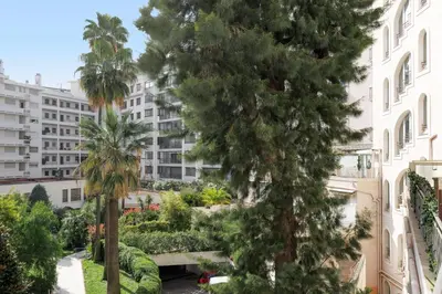 a view from the balcony of a building with trees at Palais Miramar YourHostHelper in Cannes