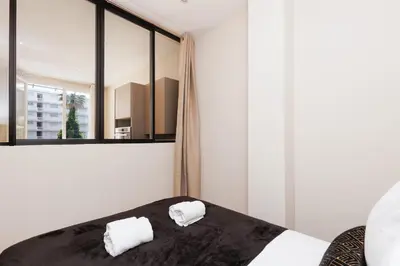 a bedroom with a bed with two towels on it at Palais Miramar YourHostHelper in Cannes