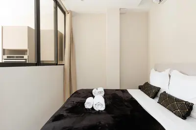 a bedroom with a bed with two shoes on it at Palais Miramar YourHostHelper in Cannes