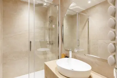 a bathroom with a sink and a shower at Palais Miramar YourHostHelper in Cannes