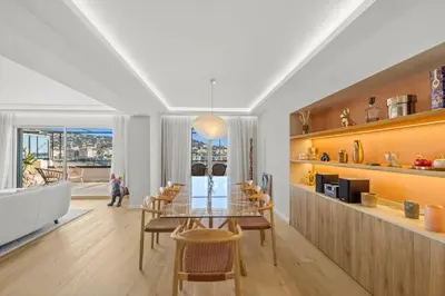 a dining room with a table and chairs and a window at REF 1923 - Cannes Vieux-Port 5-star penthouse for rent sea view in Cannes