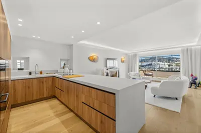 a kitchen with a white counter and a living room at REF 1923 - Cannes Vieux-Port 5-star penthouse for rent sea view in Cannes