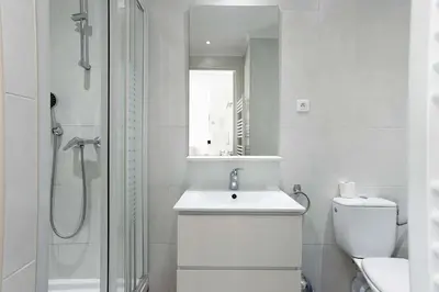 a bathroom with a toilet and a sink and a shower at Rue Hoche by Halldis in Cannes