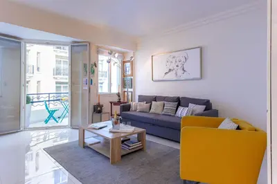 a living room with a couch and a table at Palais Des Iles 2 by Halldis in Cannes